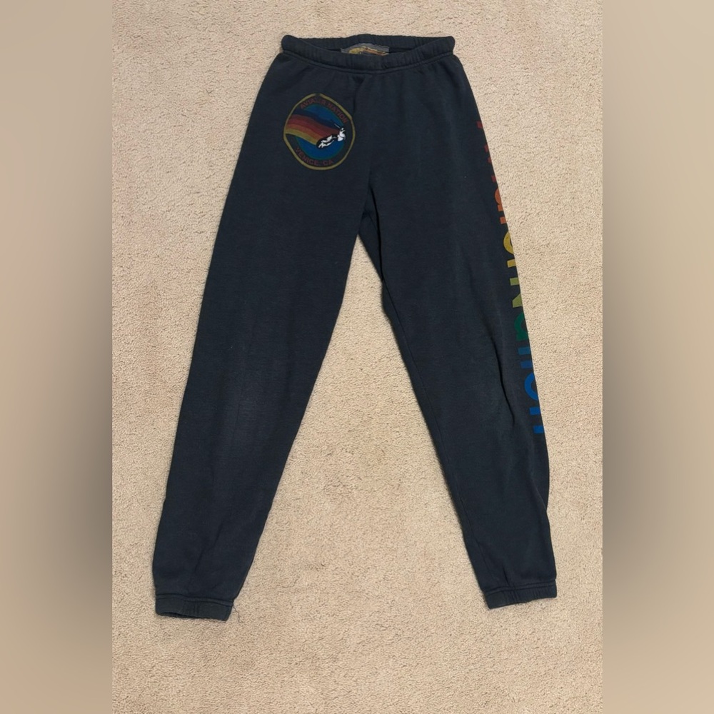 Black Aviation Nation sweatpants with rainbow lettering down the side